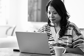 A woman using a laptop to file her taxes.