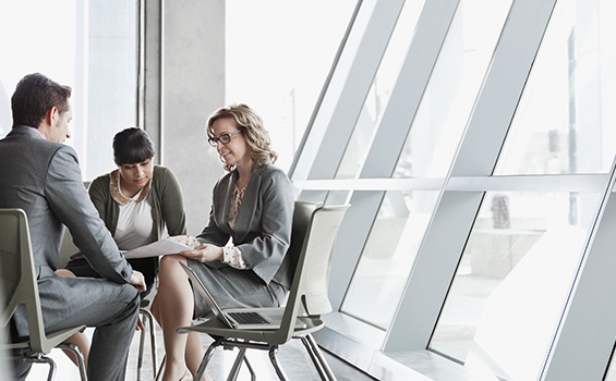 Work colleagues in grey suits meeting